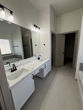 a bathroom with a double vanity sink and mirror