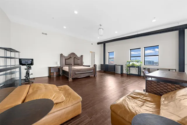 a living room with furniture and wooden floor