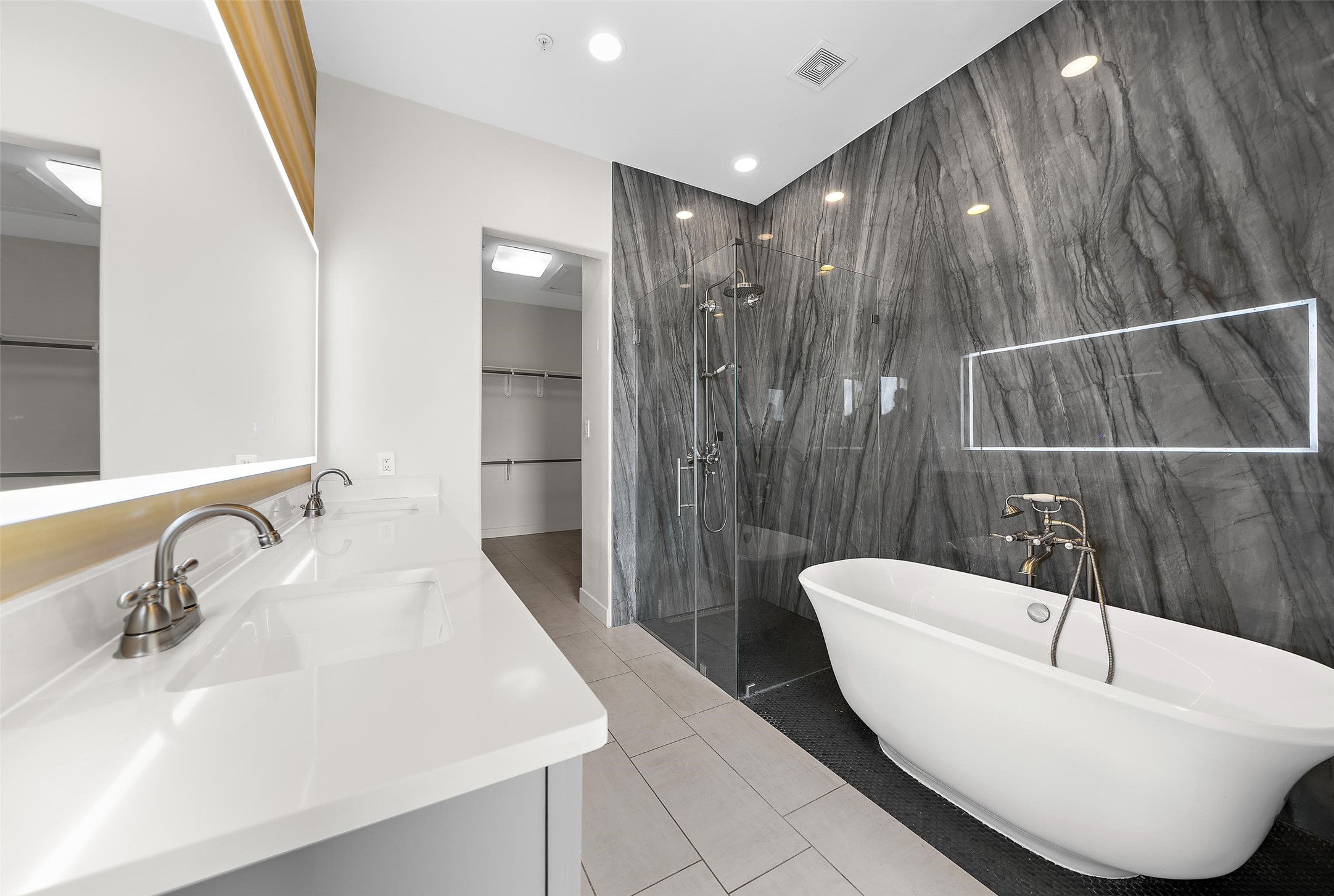 2323 Polk Street, Unit 306 Houston, TX 77003 - Photo 13 of 32 a bathroom with a sink a toilet a shower and a mirror