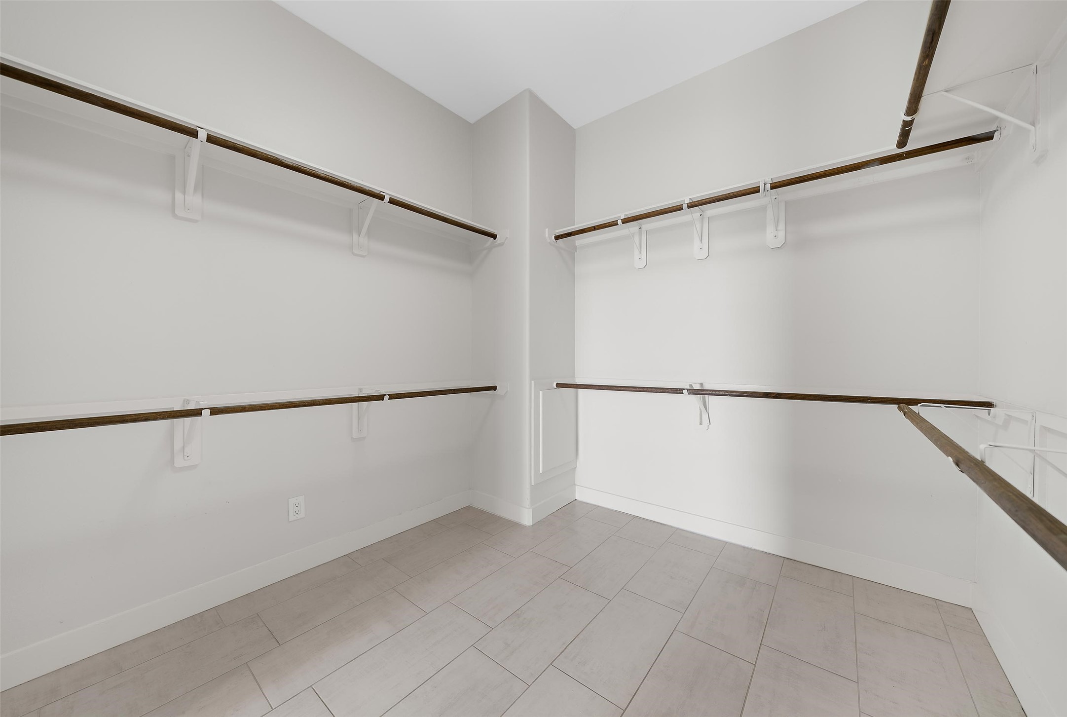 2323 Polk Street, Unit 306 Houston, TX 77003 - Photo 16 of 32 a view of an empty walk in closet with empty racks