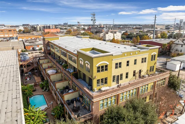 a view of a blue house with large windows