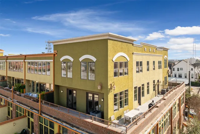 an aerial view of a house with garden space and swimming pool