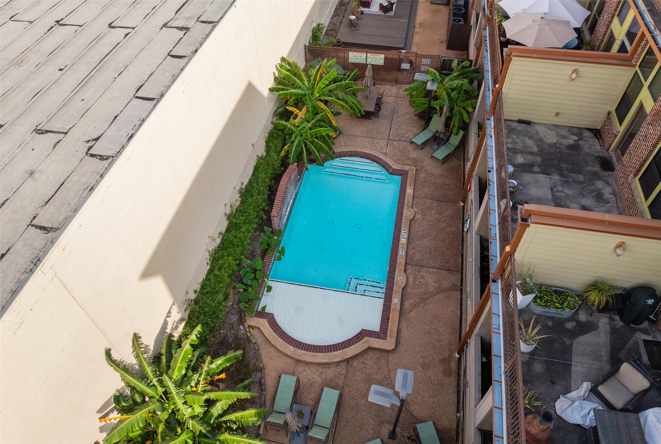 2323 Polk Street, Unit 306 Houston, TX 77003 - Photo 26 of 32 an aerial view of a house with garden space and swimming pool
