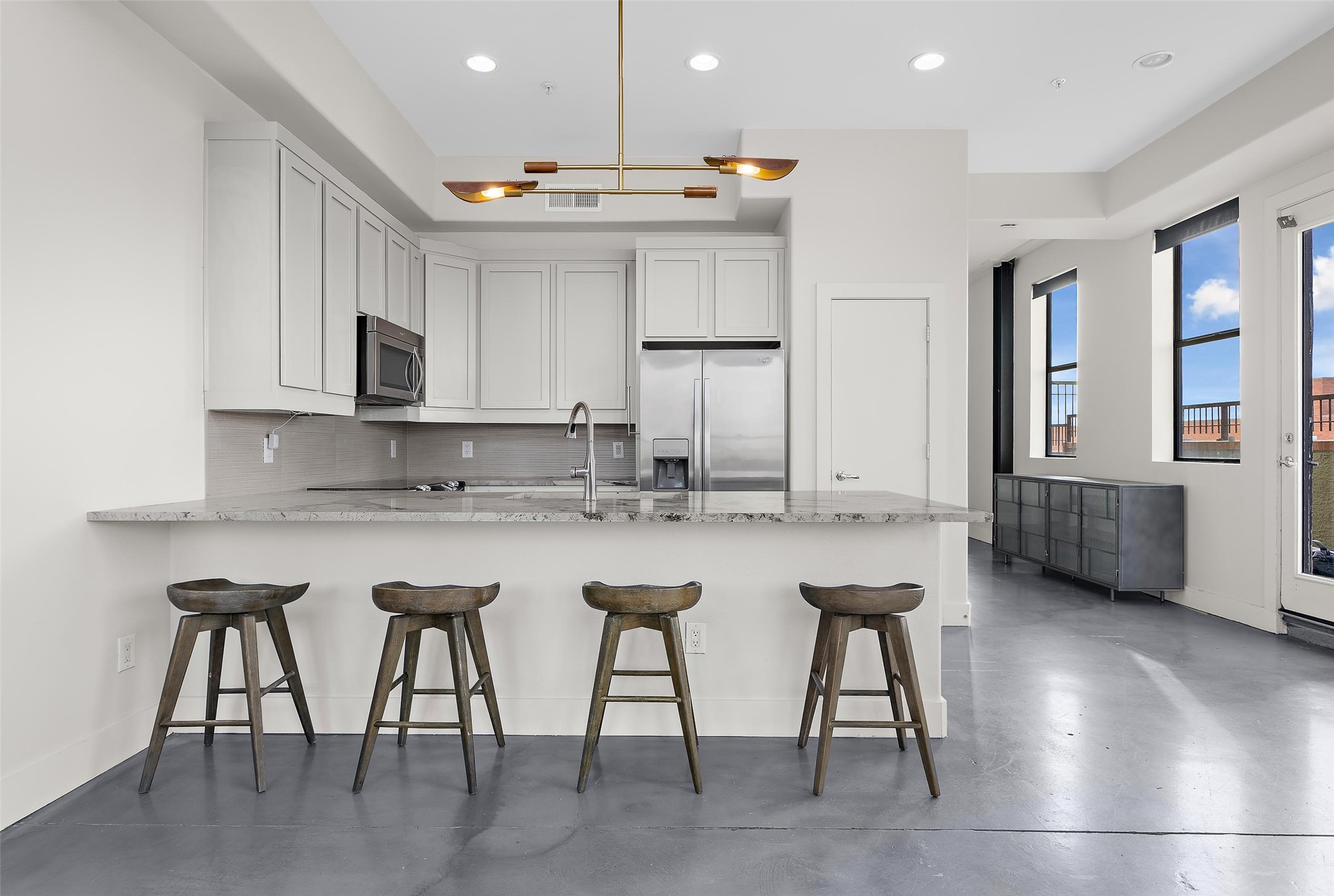 2323 Polk Street, Unit 306 Houston, TX 77003 - Photo 7 of 32 a kitchen with stainless steel appliances granite countertop a table chairs sink and cabinets