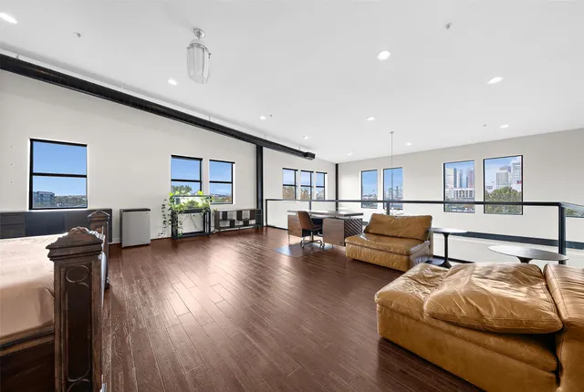 a living room with furniture and wooden floor