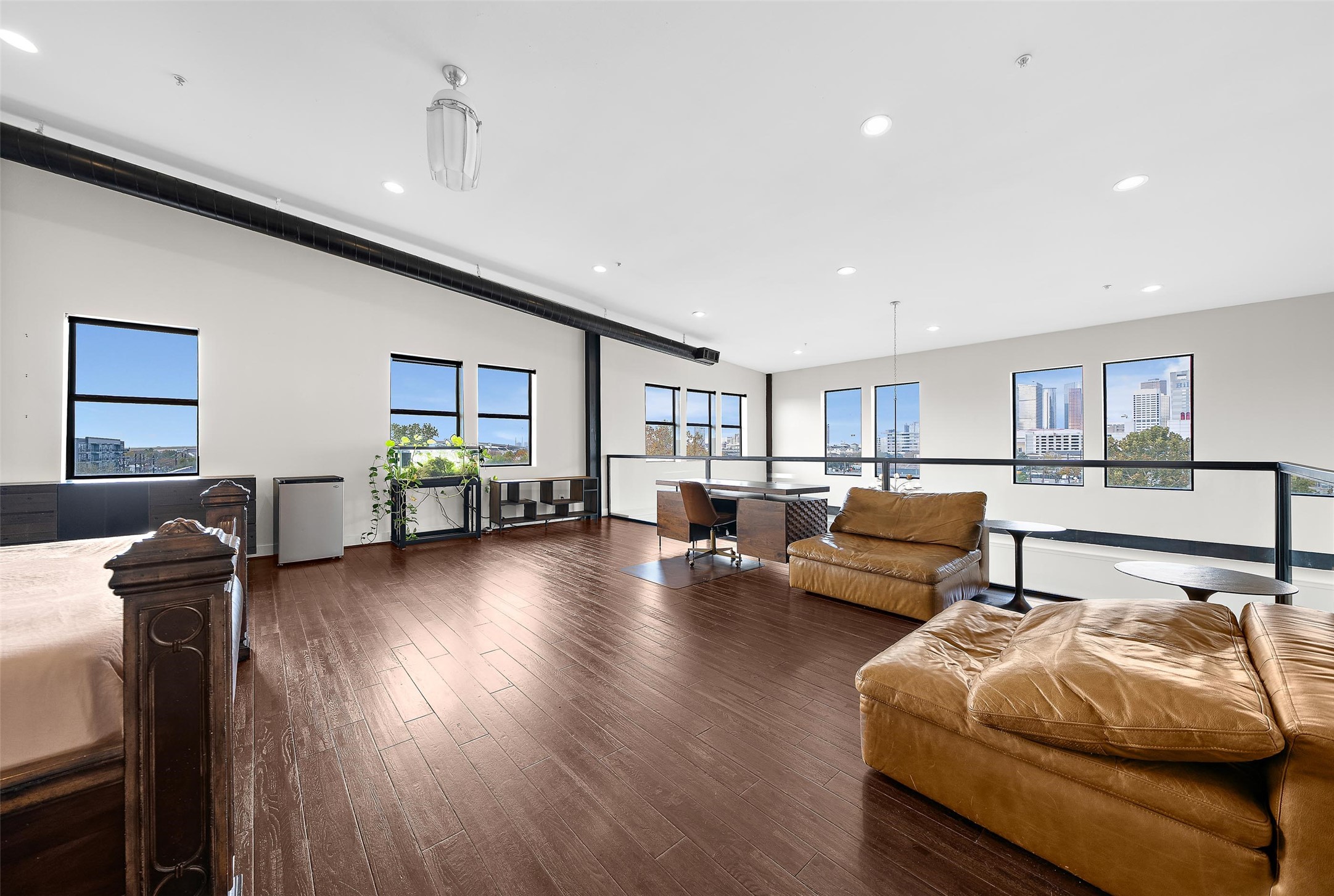 2323 Polk Street, Unit 306 Houston, TX 77003 - Photo 10 of 32 a living room with furniture and a wooden floor