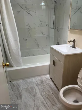 a bathroom with a bathtub and a sink