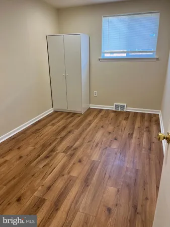 an empty room with wooden floor