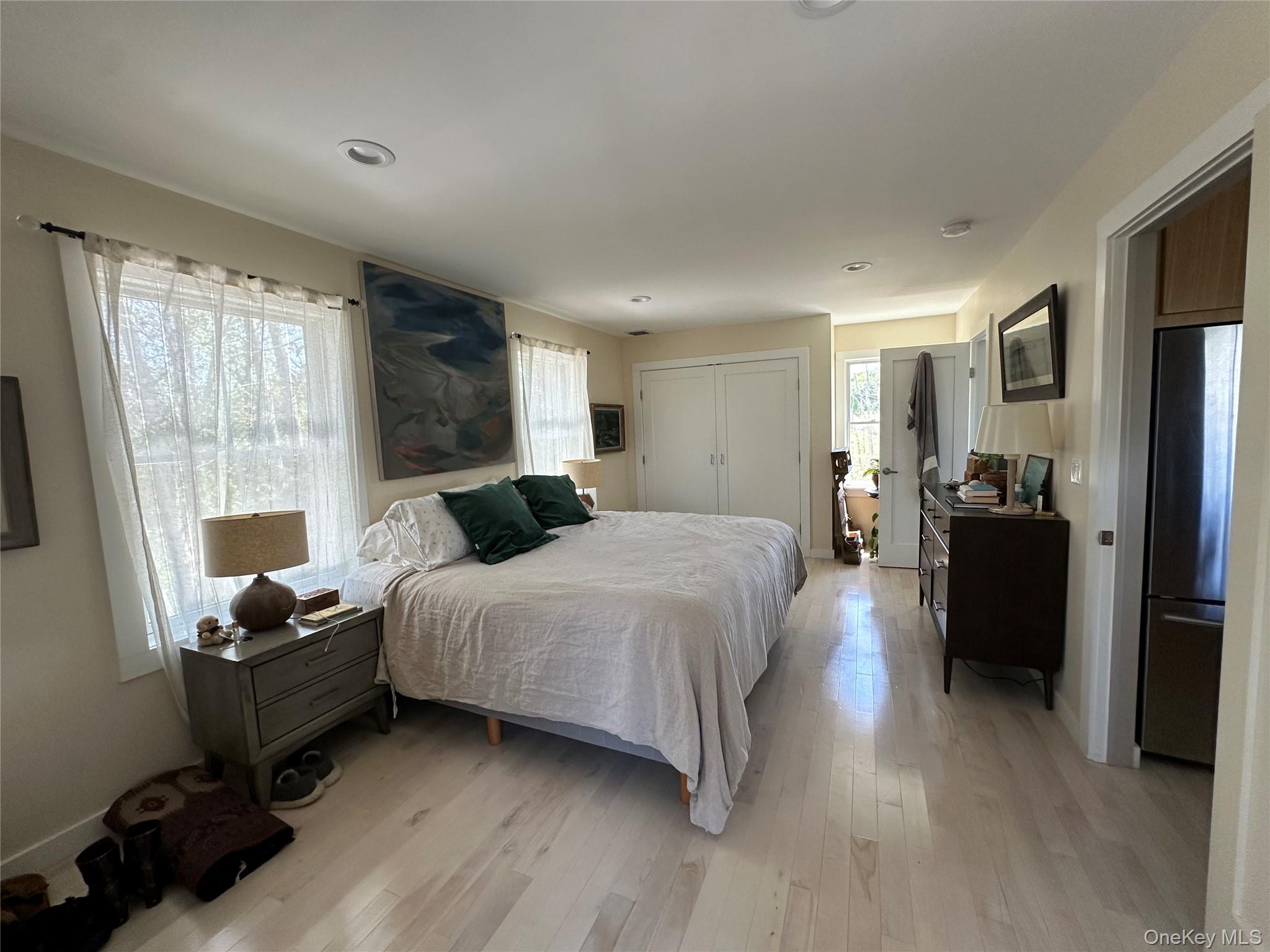 1854 North Bayview Road Southold, NY 11971 - Photo 18 of 20 Bedroom featuring freestanding refrigerator, light wood-type flooring, a closet, and recessed lighting