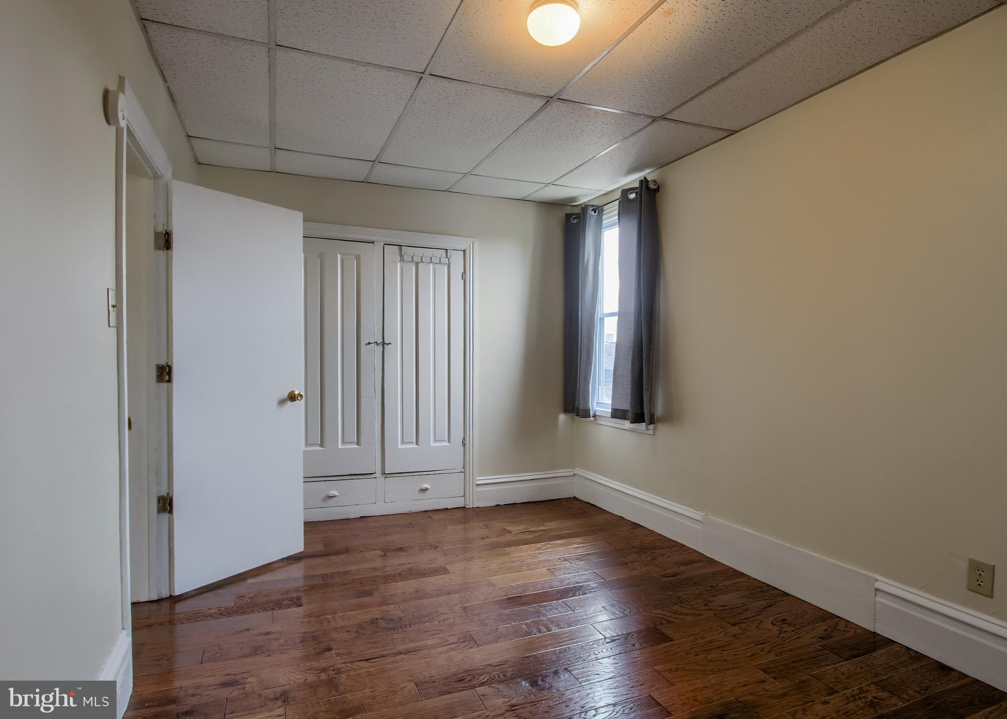 342 South 3rd Street Steelton, PA 17113 - Photo 11 of 25 an empty room with wooden floor and windows
