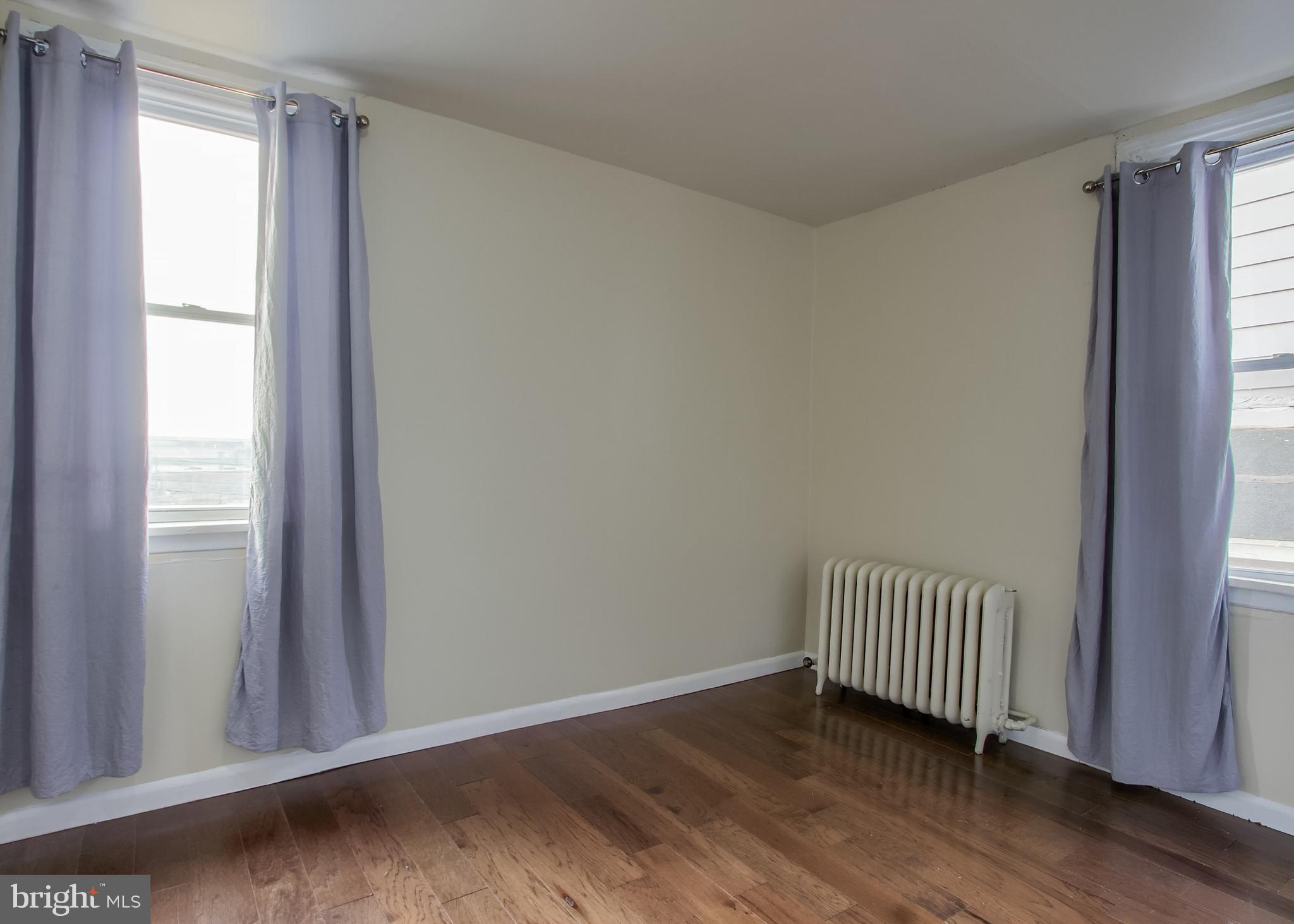 342 South 3rd Street Steelton, PA 17113 - Photo 16 of 25 an empty room with wooden floor and windows