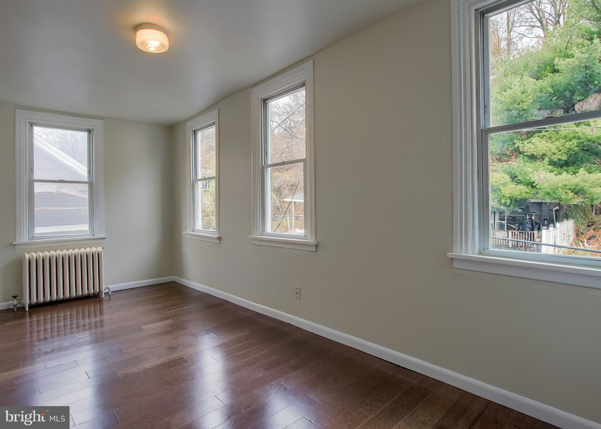 342 South 3rd Street Steelton, PA 17113 - Photo 17 of 25 an empty room with wooden floor and windows