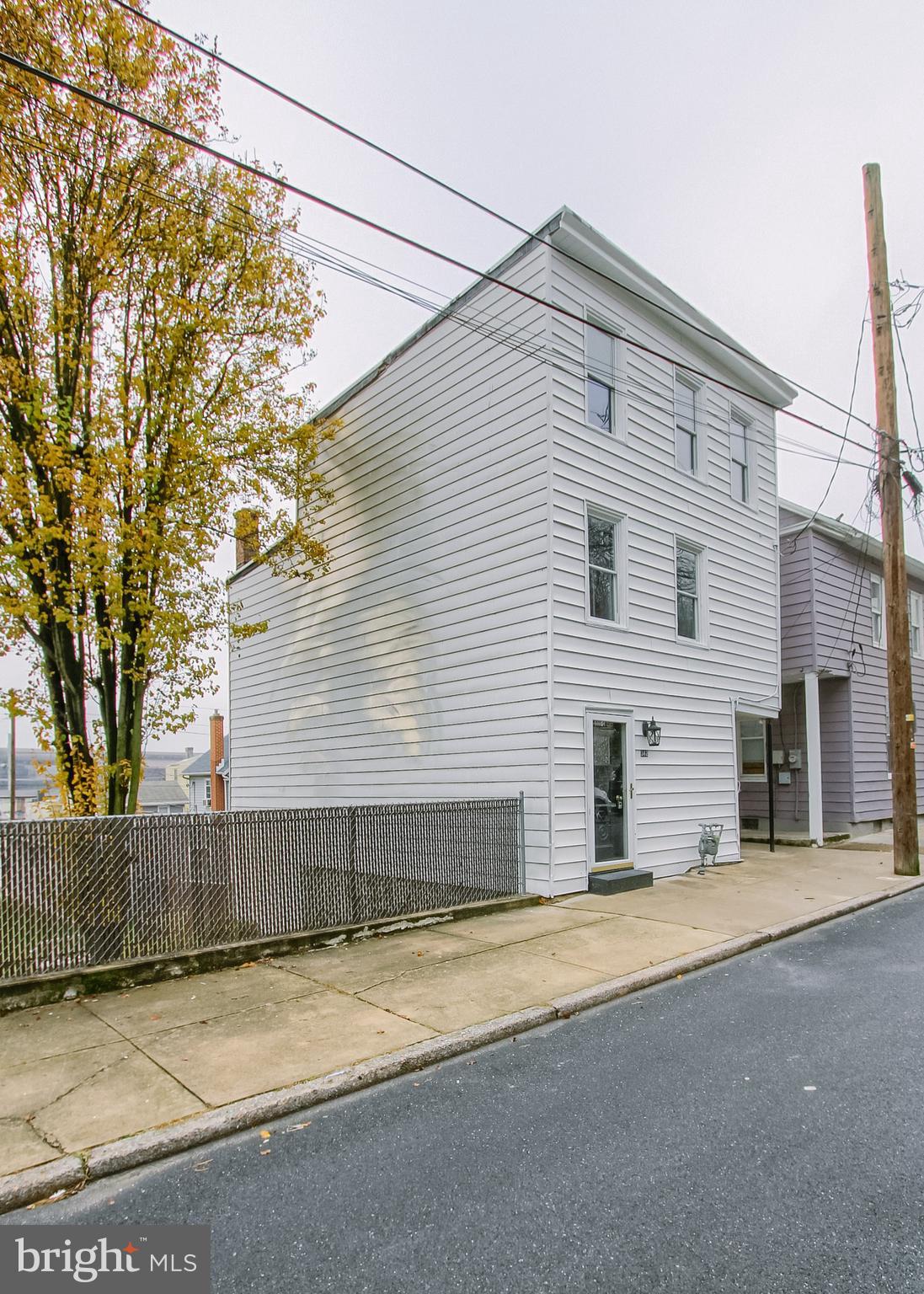 342 South 3rd Street Steelton, PA 17113 - Photo 2 of 25 a front view of a house with a yard and garage