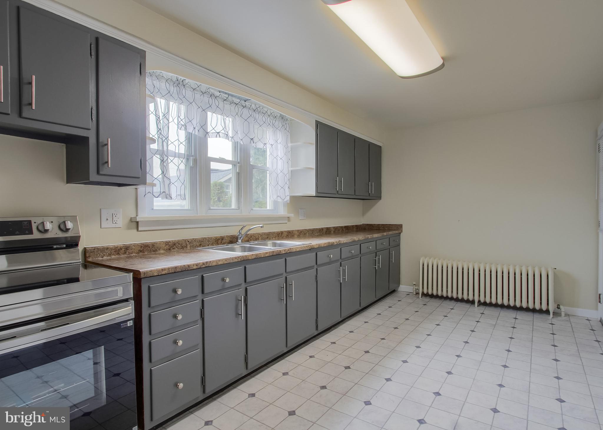 342 South 3rd Street Steelton, PA 17113 - Photo 8 of 25 a kitchen with sink cabinets and window