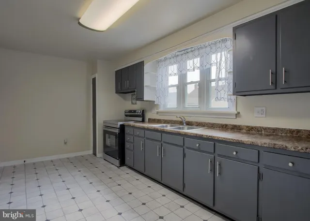 a kitchen with a sink window and cabinets