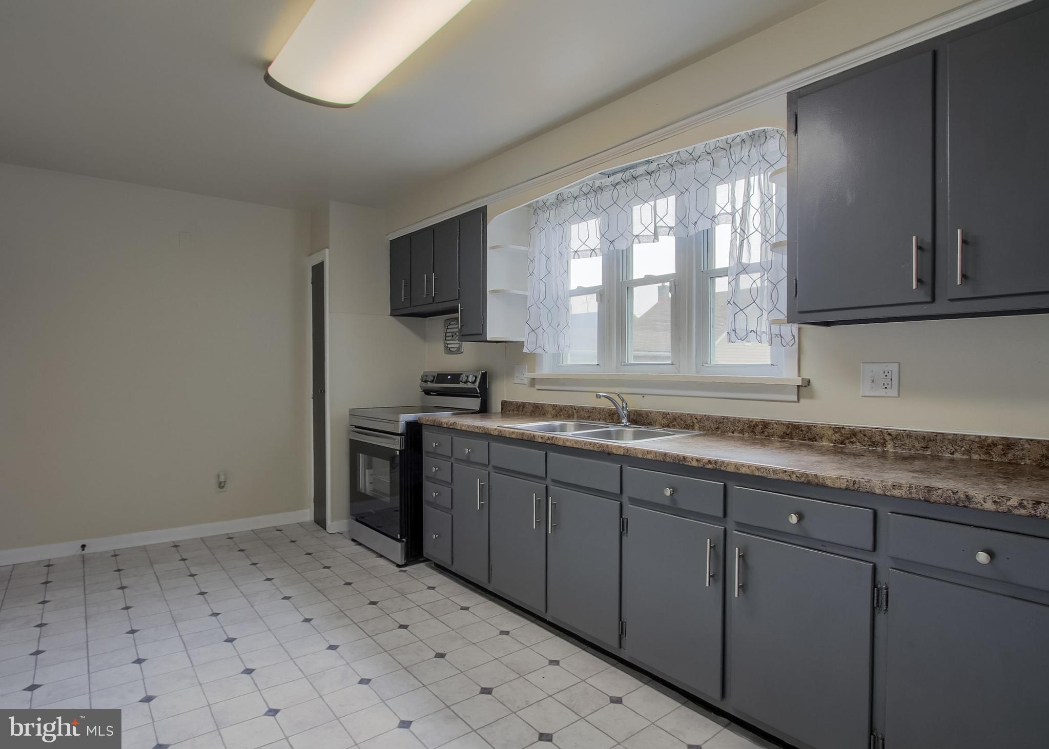 342 South 3rd Street Steelton, PA 17113 - Photo 9 of 25 a kitchen with a sink window and cabinets