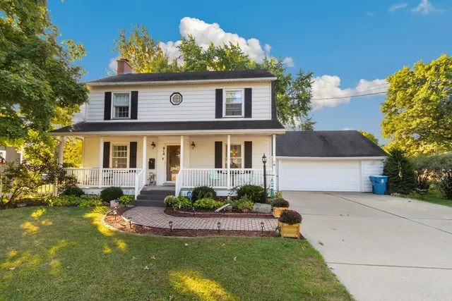 a front view of a house with a yard table and chairs
