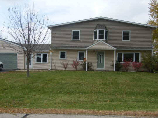 6936 South Sarah Avenue Rochelle, IL 61068 - Photo 1 of 10 a front view of a house with a garden