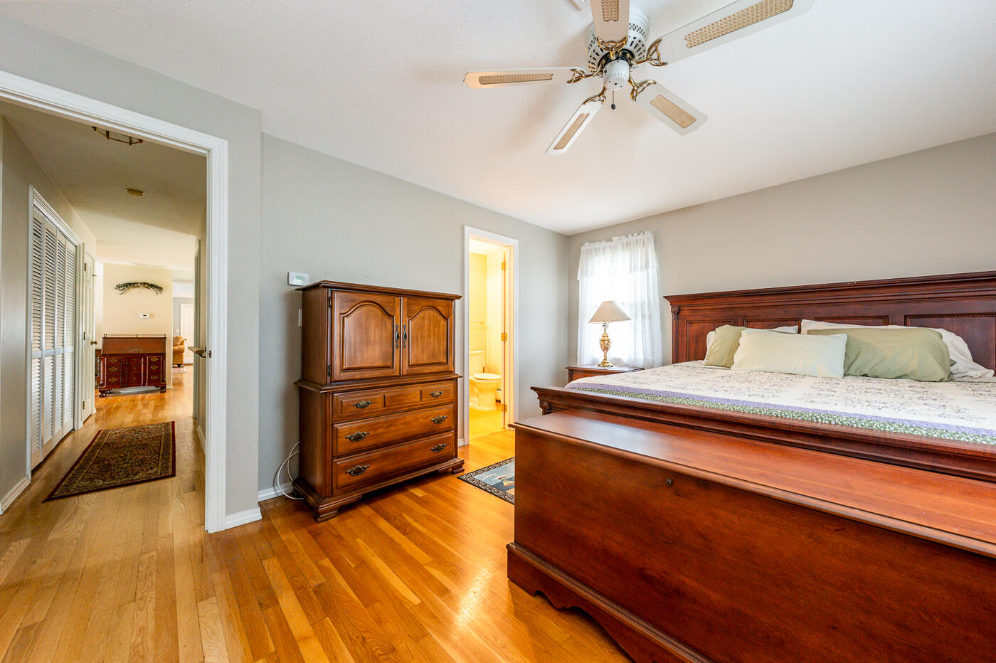 348 Prince Hinckley Road Centerville, MA 02632 - Photo 16 of 31 a bedroom with a bed and a chandelier