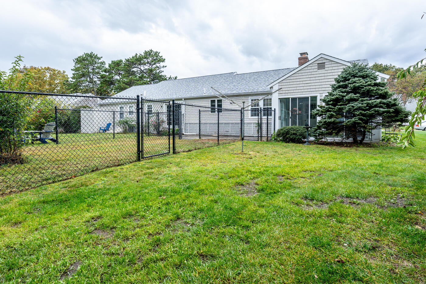348 Prince Hinckley Road Centerville, MA 02632 - Photo 28 of 31 a view of a house with a yard and sitting area