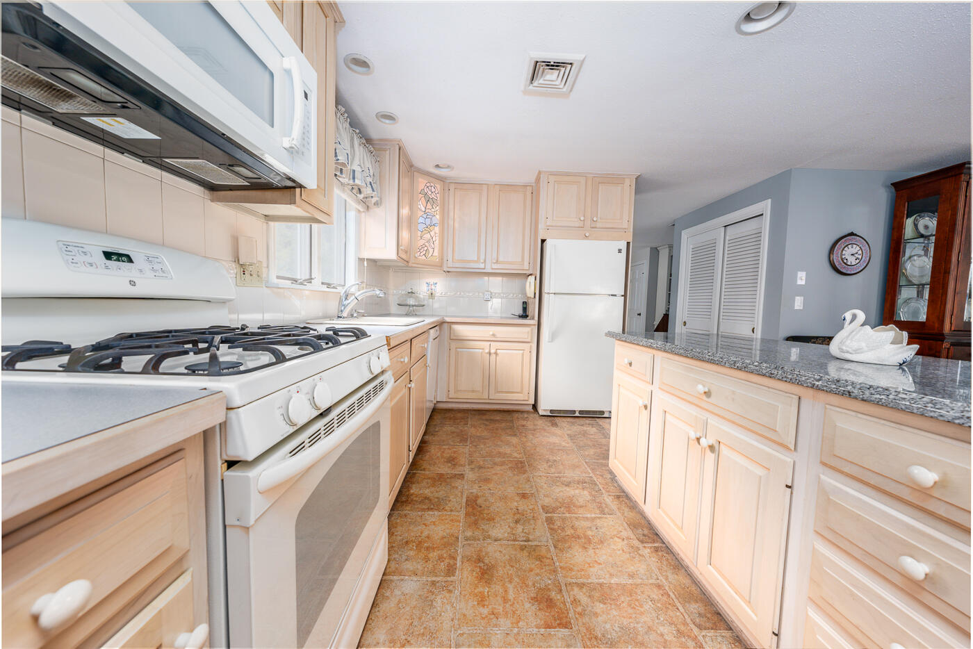 348 Prince Hinckley Road Centerville, MA 02632 - Photo 6 of 31 a kitchen with granite countertop a sink stove and refrigerator