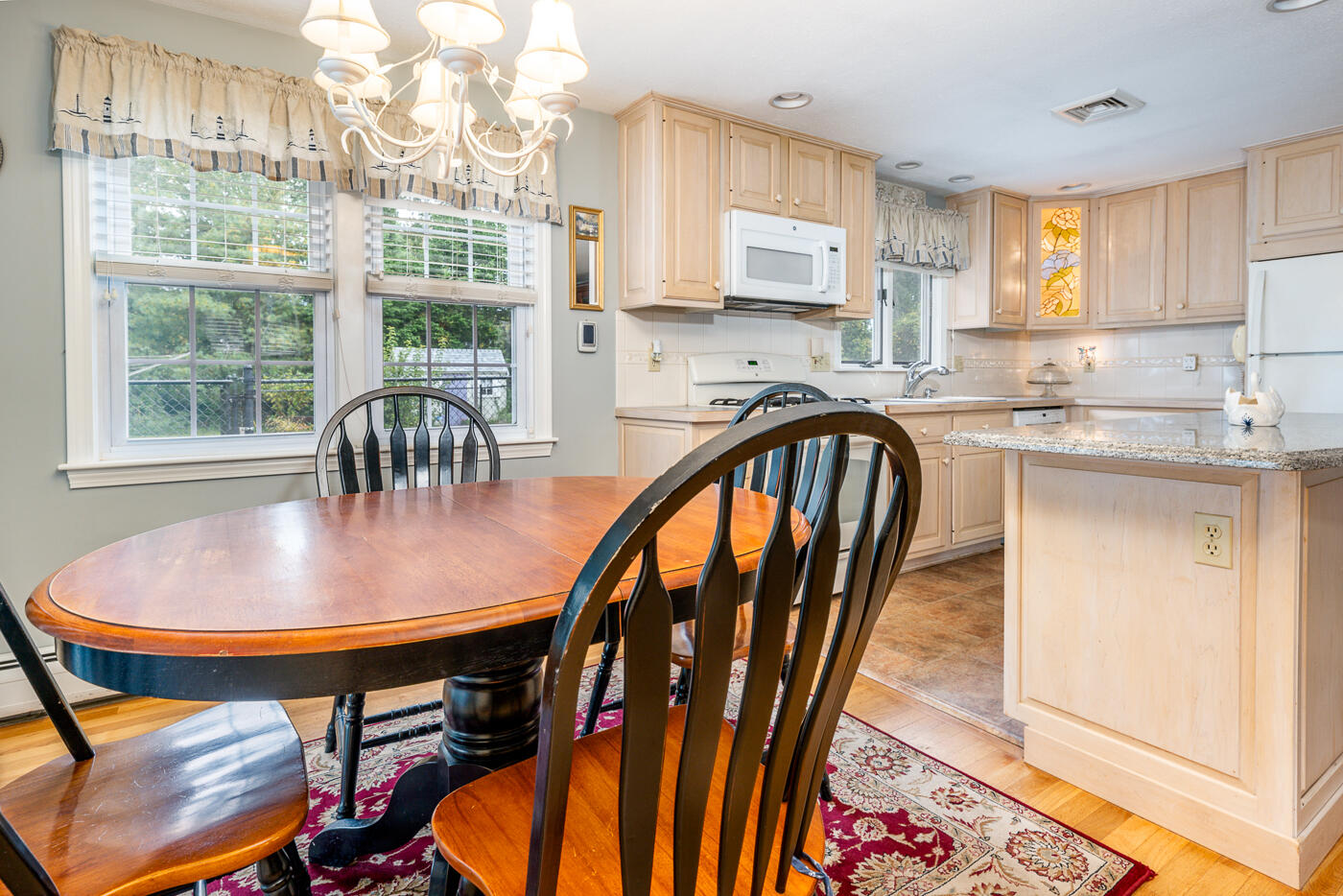 348 Prince Hinckley Road Centerville, MA 02632 - Photo 7 of 31 a dining room with furniture a rug and wooden floor