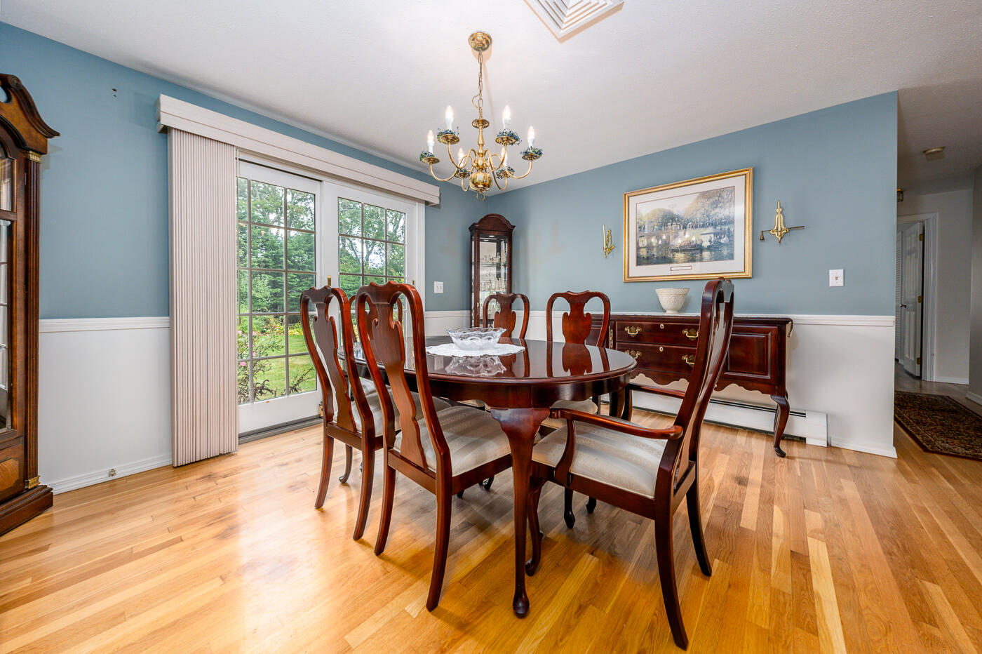 348 Prince Hinckley Road Centerville, MA 02632 - Photo 9 of 31 a view of a dining room with furniture a chandelier and wooden floor