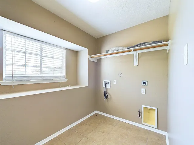 a view of a room with rack on the wall and a window