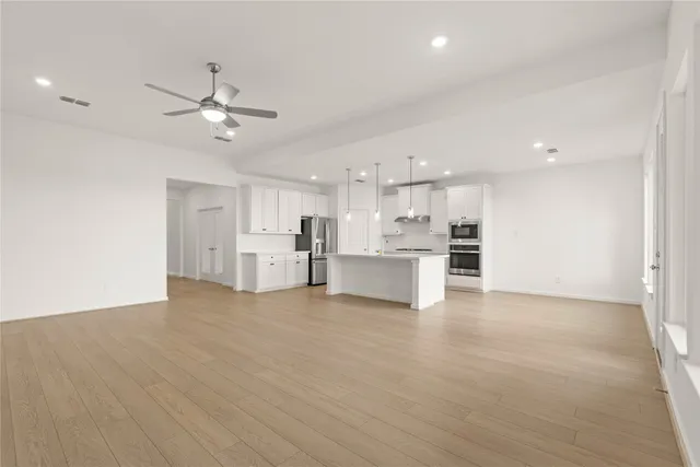 a view of kitchen with wooden floor and windows