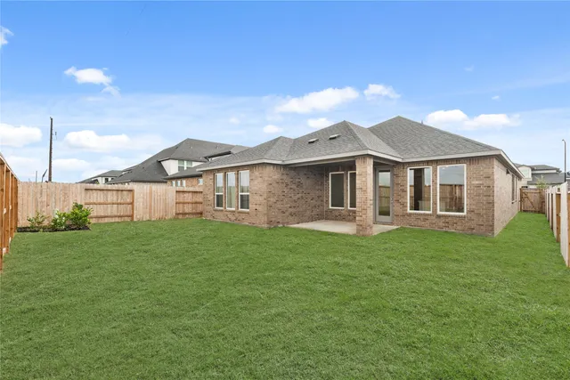 a view of a yard with a house in the background