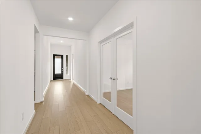 a view of a hallway with wooden floor