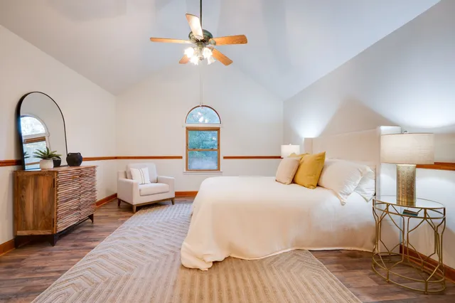 a bedroom with bed and wooden floor
