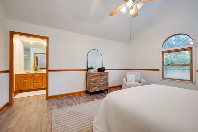 a bedroom with a bed and a mirror