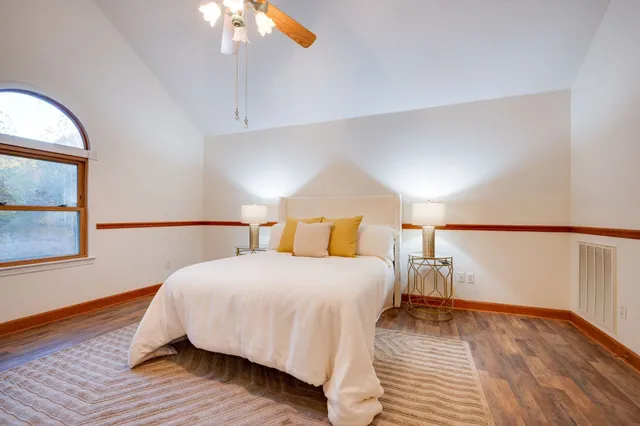 a bathroom with a double vanity sink a mirror and a bathtub