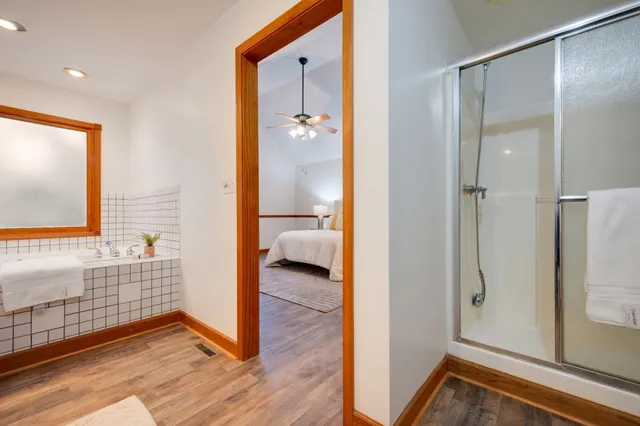 a bedroom with a bed and a potted plant