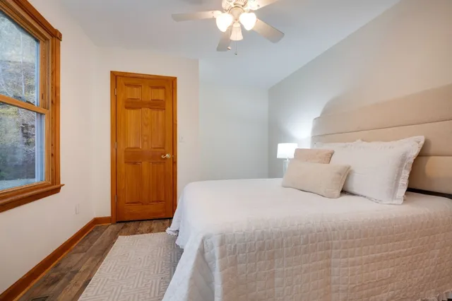 a bedroom with a large bed and a large window