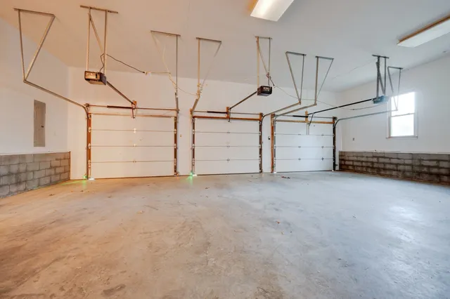 a view of a house with a yard and large tree