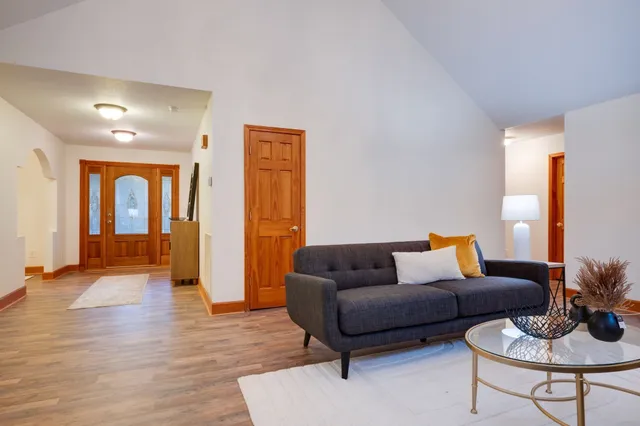 a living room with furniture and wooden floor