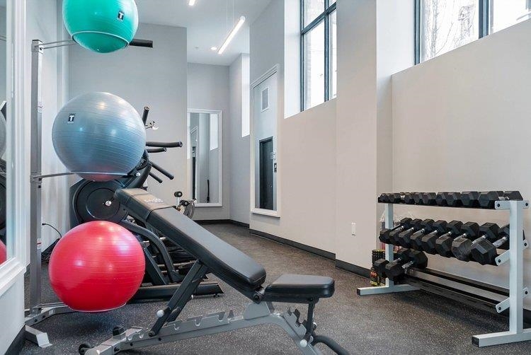 119 Peter Street, Unit 403 Union City, NJ 07087 - Photo 13 of 15 a room with wooden floor and gym equipment