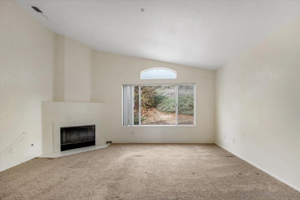 9704 Avenida Ricardo Spring Valley, CA 91977 - Photo 23 of 52 an empty room with windows and fireplace