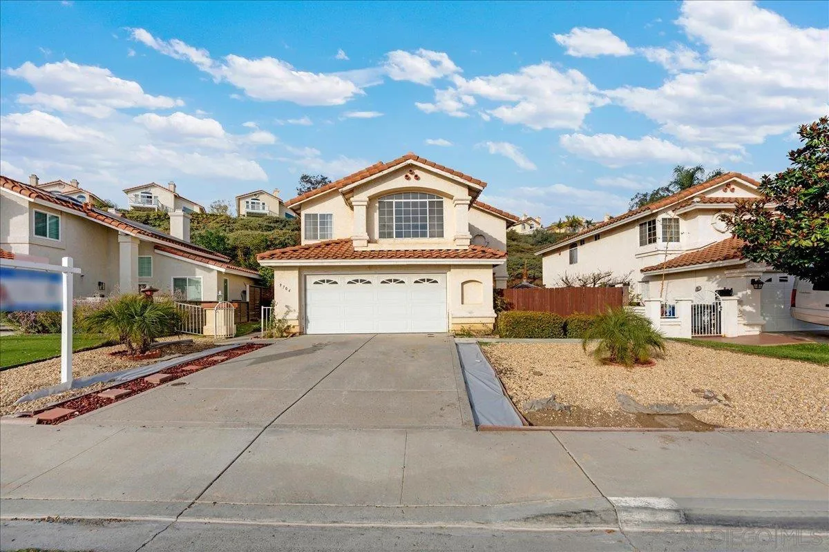9704 Avenida Ricardo Spring Valley, CA 91977 - Photo 35 of 52 a front view of a house with a yard and garage