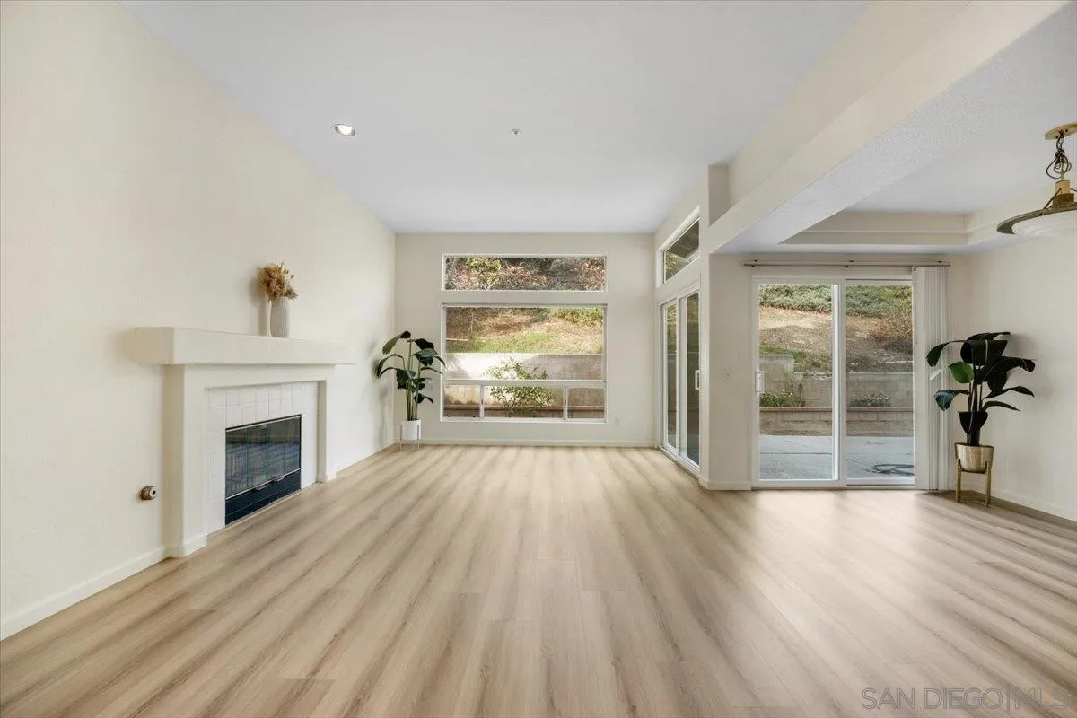 9704 Avenida Ricardo Spring Valley, CA 91977 - Photo 5 of 52 wooden floor fireplace and windows in an empty room