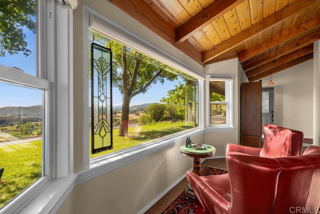25443 Mesa Grande Road Santa Ysabel, CA 92070 - Photo 16 of 68 a living room with furniture and a floor to ceiling window