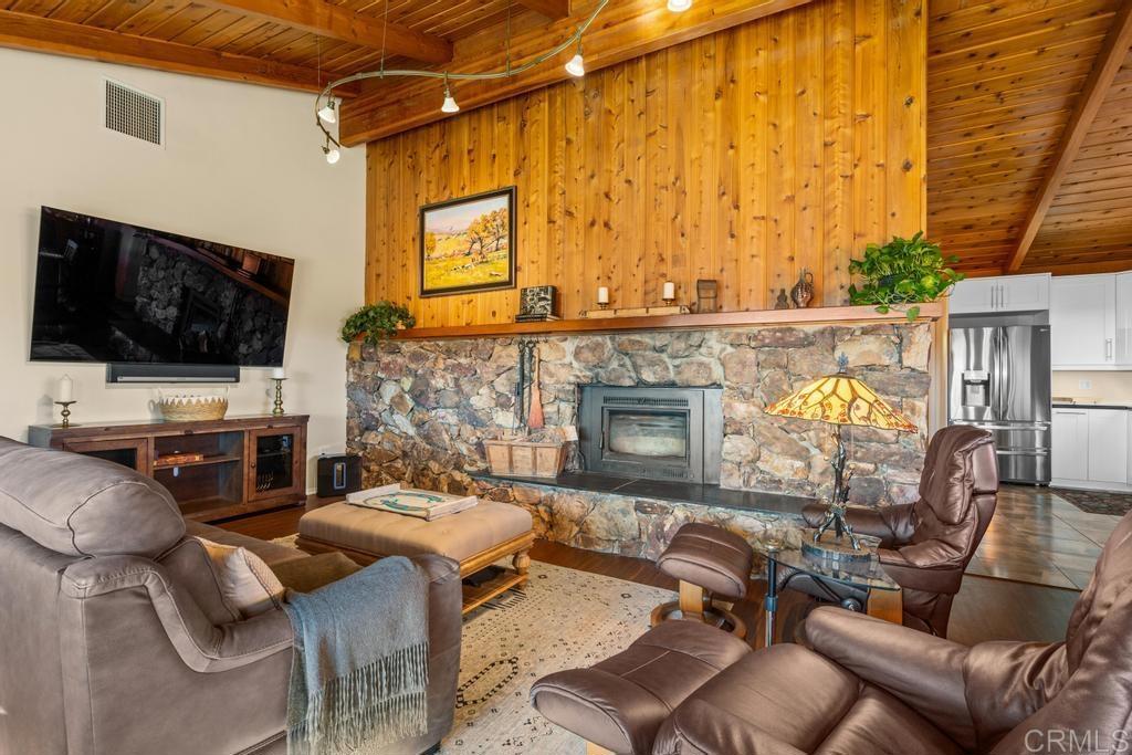 25443 Mesa Grande Road Santa Ysabel, CA 92070 - Photo 18 of 68 a living room with furniture a flat screen tv and a fireplace