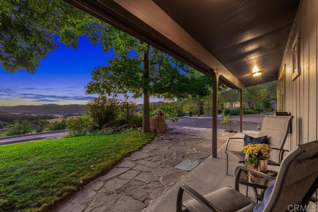 25443 Mesa Grande Road Santa Ysabel, CA 92070 - Photo 3 of 68 a view of a patio with table and chairs potted plants with wooden floor and fence