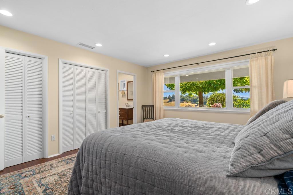25443 Mesa Grande Road Santa Ysabel, CA 92070 - Photo 33 of 68 a spacious bedroom with a large bed and a window