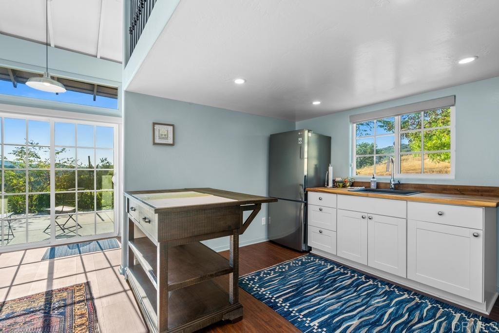 25443 Mesa Grande Road Santa Ysabel, CA 92070 - Photo 52 of 68 a kitchen with a sink and wooden cabinets