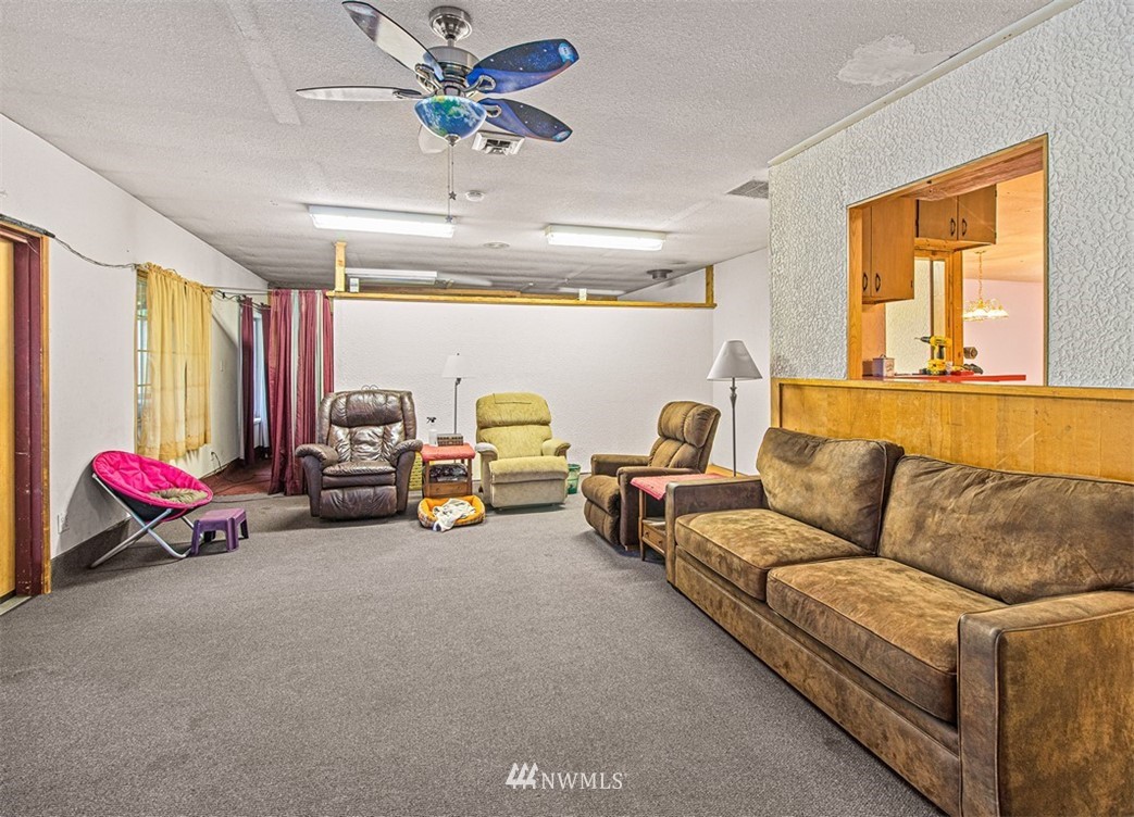 20128 Carper Road Southwest Rochester, WA 98579 - Photo 11 of 19 a living room with furniture and a chandelier