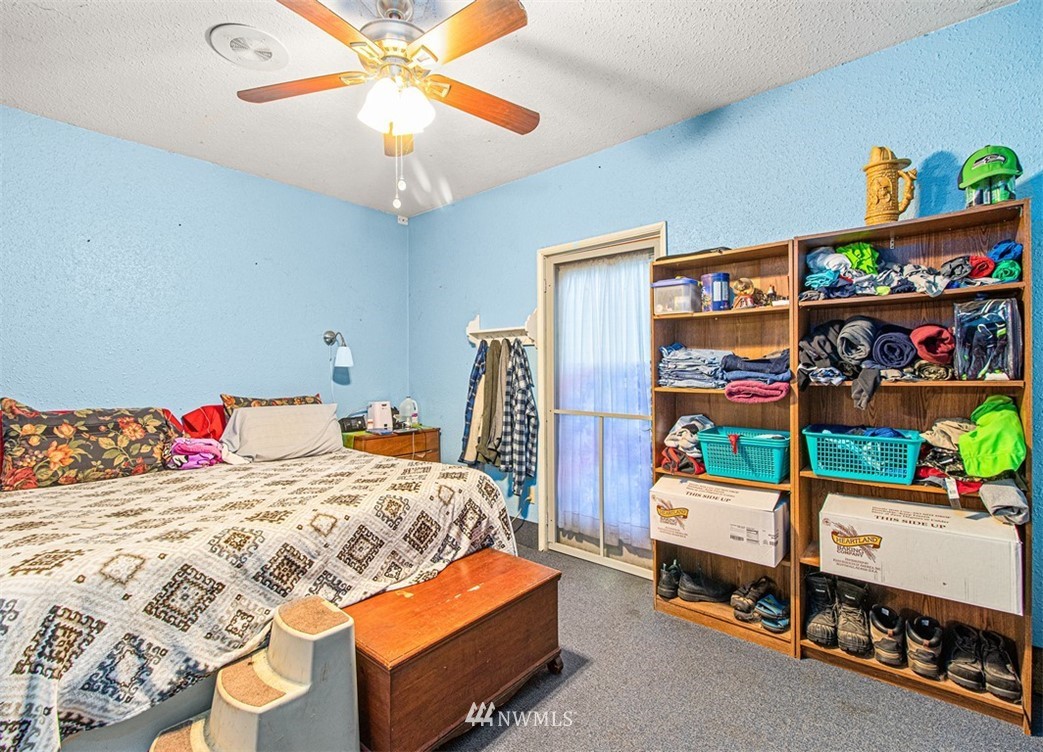 20128 Carper Road Southwest Rochester, WA 98579 - Photo 16 of 19 a bedroom with a bed and a chandelier