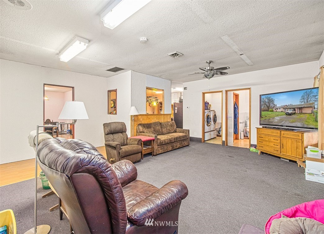 20128 Carper Road Southwest Rochester, WA 98579 - Photo 10 of 19 a living room with furniture and a flat screen tv